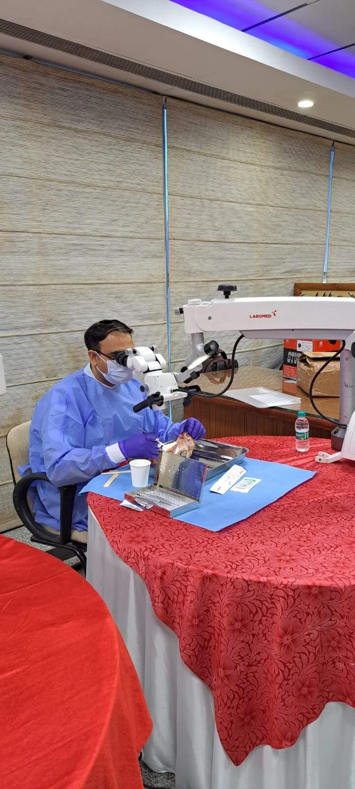 Dr. Gautam Sharma practising with a dental microscope on a training model
