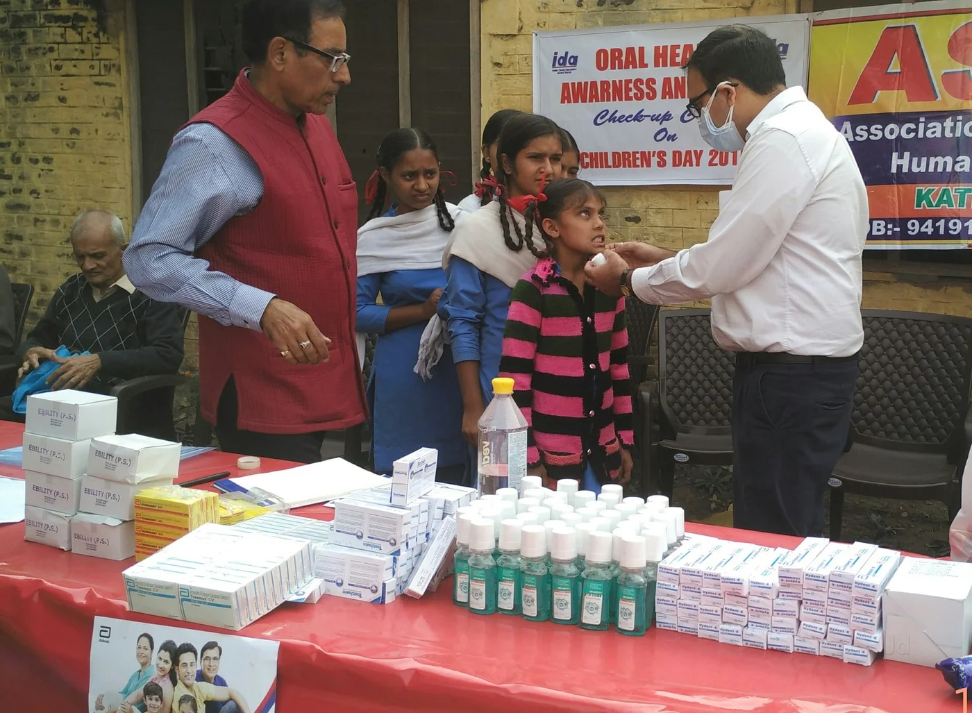 Dr. Gautam Sharma conducting a dental check-up at a children’s outreach camp